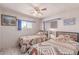 Well-lit bedroom with wood-look flooring and two twin beds at 2700 E Allred Ave # R87, Mesa, AZ 85204