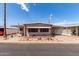 Charming single-story home with well-maintained landscaping and covered parking on a sunny day at 2700 E Allred Ave # R87, Mesa, AZ 85204