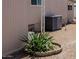 Exterior shot of the home with an AC unit, rock landscaping, and tropical plants at 2700 E Allred Ave # R87, Mesa, AZ 85204