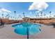 Community pool surrounded by lounge chairs, tables, and shady umbrellas at 2700 E Allred Ave # R87, Mesa, AZ 85204