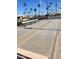 Outdoor shuffleboard court with seating and palm tree landscaping, providing a recreational amenity at 2700 E Allred Ave # R87, Mesa, AZ 85204