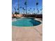 Outdoor swimming pool with clear blue water, surrounded by a concrete deck and palm trees at 2700 E Allred Ave # R87, Mesa, AZ 85204