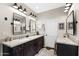 Bathroom featuring double vanity with granite countertop and dark wood cabinetry at 3209 E Fox St, Mesa, AZ 85213