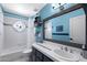 Bright bathroom with blue accent wall, decorative stained glass, large mirror, and tile countertop at 3209 E Fox St, Mesa, AZ 85213