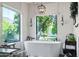 Bright bathroom features a standalone tub with a view to the backyard at 3209 E Fox St, Mesa, AZ 85213