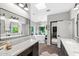 Bright bathroom featuring tub, walk-in closet and double vanity with granite countertop at 3209 E Fox St, Mesa, AZ 85213