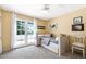 Bright bedroom with a double bed and a french door overlooking the balcony at 3209 E Fox St, Mesa, AZ 85213