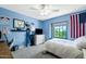 Bright bedroom with baseball themed décor and a view to the backyard at 3209 E Fox St, Mesa, AZ 85213