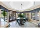 Dining room with chandelier and views through the windows and doors at 3209 E Fox St, Mesa, AZ 85213