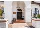 Inviting front entryway showcasing a decorative chandelier, elegant double doors, and textured stucco walls at 3209 E Fox St, Mesa, AZ 85213