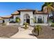 Charming home featuring a Spanish tile roof, arched entryway, and well-manicured desert landscaping at 3209 E Fox St, Mesa, AZ 85213