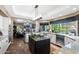 Open kitchen design with granite countertops, island cooktop, and stainless appliances at 3209 E Fox St, Mesa, AZ 85213