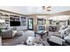 Cozy living room with built-in shelves, a ceiling fan, and an open layout connecting to the kitchen at 3209 E Fox St, Mesa, AZ 85213
