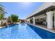 The sparkling pool with waterfall is centrally located near outdoor seating and covered patio at 3209 E Fox St, Mesa, AZ 85213