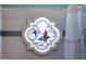 Close-up of decorative stained glass window with butterfly and floral motif in bathroom at 3209 E Fox St, Mesa, AZ 85213