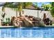This sparkling pool boasts a natural rock waterfall feature adding a touch of luxury to the backyard at 3209 E Fox St, Mesa, AZ 85213