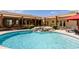 Serene backyard with custom pool, rock waterfall, covered patio, and lush desert landscape at 37809 N 9Th Pl, Phoenix, AZ 85086