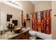 Bathroom with granite countertops, vessel sink, and colorful shower curtain at 37809 N 9Th Pl, Phoenix, AZ 85086