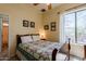 Well-lit bedroom featuring a queen bed, tile floors, and bright windows at 37809 N 9Th Pl, Phoenix, AZ 85086