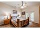 Cozy bedroom featuring wood furniture, a ceiling fan, and a door to the exterior at 37809 N 9Th Pl, Phoenix, AZ 85086