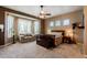 Comfortable bedroom with a sitting area by the bay window and a ceiling fan at 37809 N 9Th Pl, Phoenix, AZ 85086