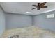 Neutral bonus room featuring wood look flooring, modern ceiling fan, and bright natural light at 37809 N 9Th Pl, Phoenix, AZ 85086