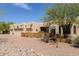 Exterior elevation of home with three car garage, desert landscaping, and a privacy wall at 37809 N 9Th Pl, Phoenix, AZ 85086