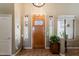 Entry foyer featuring stained glass sidelights, tile flooring, and light wood door at 37809 N 9Th Pl, Phoenix, AZ 85086