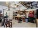 Organized garage featuring a large workbench, multiple power tools, shelving, and rolling tool chest at 37809 N 9Th Pl, Phoenix, AZ 85086
