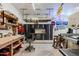 A well-organized garage with built-in cabinets, shelving, work bench, and overhead storage at 37809 N 9Th Pl, Phoenix, AZ 85086