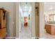 Open hallway featuring recessed lighting and views into the kitchen and another room at 37809 N 9Th Pl, Phoenix, AZ 85086
