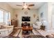 Cozy living room featuring comfortable seating, ceiling fan, and a TV at 37809 N 9Th Pl, Phoenix, AZ 85086