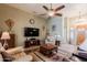 Inviting living room features tile floors, ceiling fan, and a comfortable seating arrangement at 37809 N 9Th Pl, Phoenix, AZ 85086