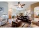 Open-concept living room with tile floors, ceiling fan, and access to the dining area at 37809 N 9Th Pl, Phoenix, AZ 85086