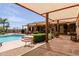 Beautiful backyard featuring custom pool with waterfall, covered patio, and stone pavers at 37809 N 9Th Pl, Phoenix, AZ 85086