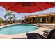 Resort-style backyard pool area with lush landscaping, waterfall feature, and shaded lounge area at 37809 N 9Th Pl, Phoenix, AZ 85086