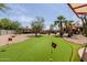 Backyard putting green next to home with shaded seating and access to the pool area at 37809 N 9Th Pl, Phoenix, AZ 85086