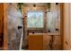 Beautiful walk-in shower with stone tile, dual shower heads, and a window at 37809 N 9Th Pl, Phoenix, AZ 85086