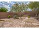 Desert landscaped backyard with flagstone features, mature plants, and a retaining wall at 41202 N Rolling Green Way, Anthem, AZ 85086