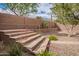 Backyard with desert landscaping, mature shrubs, and a block fence for privacy at 41202 N Rolling Green Way, Anthem, AZ 85086