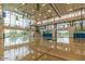 Bright and spacious indoor basketball court with polished wood floors and natural light at 41202 N Rolling Green Way, Anthem, AZ 85086