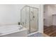 Bathroom featuring a soaking tub and a glass-enclosed shower at 41202 N Rolling Green Way, Anthem, AZ 85086