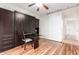 A stylish bedroom showcasing a Murphy bed, desk and storage cabinets, plus wood-look laminate flooring at 41202 N Rolling Green Way, Anthem, AZ 85086