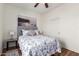 Bedroom featuring a queen bed, wood-look floors, a closet, and stylish decor at 41202 N Rolling Green Way, Anthem, AZ 85086