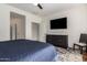 Bedroom with flat screen tv, dresser, wood-look flooring and walk-in closet at 41202 N Rolling Green Way, Anthem, AZ 85086