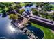 Aerial view of a park featuring a pond, miniature railway, gazebos, and lush greenery, offering a serene recreational space at 41202 N Rolling Green Way, Anthem, AZ 85086