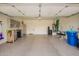 Spacious three-car garage with epoxy flooring, storage cabinets, and good lighting at 41202 N Rolling Green Way, Anthem, AZ 85086