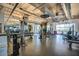 Modern gym with weightlifting equipment, treadmills, and a bright interior with large windows and well-lit space at 41202 N Rolling Green Way, Anthem, AZ 85086