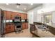 Well-lit kitchen with stainless steel appliances, granite countertops, and beautiful wooden cabinetry at 41202 N Rolling Green Way, Anthem, AZ 85086