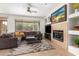 Comfortable living room with a fireplace and a large window overlooking the backyard at 41202 N Rolling Green Way, Anthem, AZ 85086